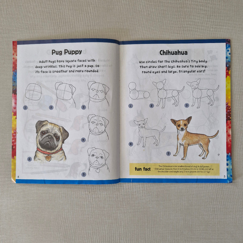 Open book with illustrations of dogs on a textured surface