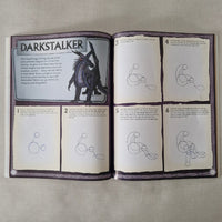 Open book with illustrations and text on a textured surface