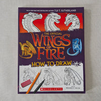 Book titled 'The Official Wings of Fire How to Draw' with dragon illustrations on a gray background