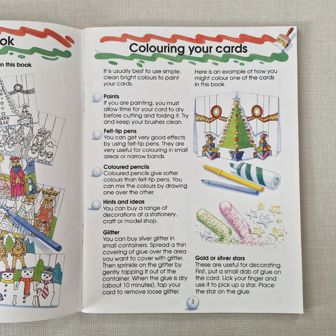 Open book with instructions on colouring cards, featuring illustrations and text.