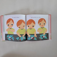 Open book page with 4 children sewing pieces of material together
