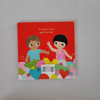 Back cover of How to Mend a Heart book with 2 children with a pile of material pieces and cotton