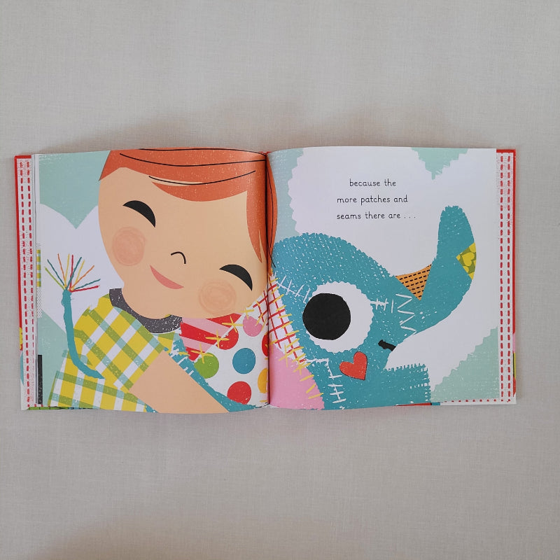 open book page showing a child cuddling an elephant