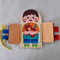 Spiral bound book with a child character and teddy bear illustration on a gray background