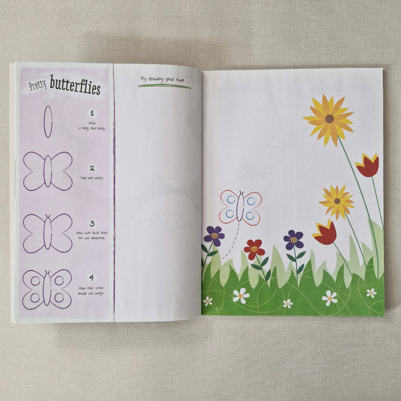 Open book with butterfly and flower illustrations on a textured surface