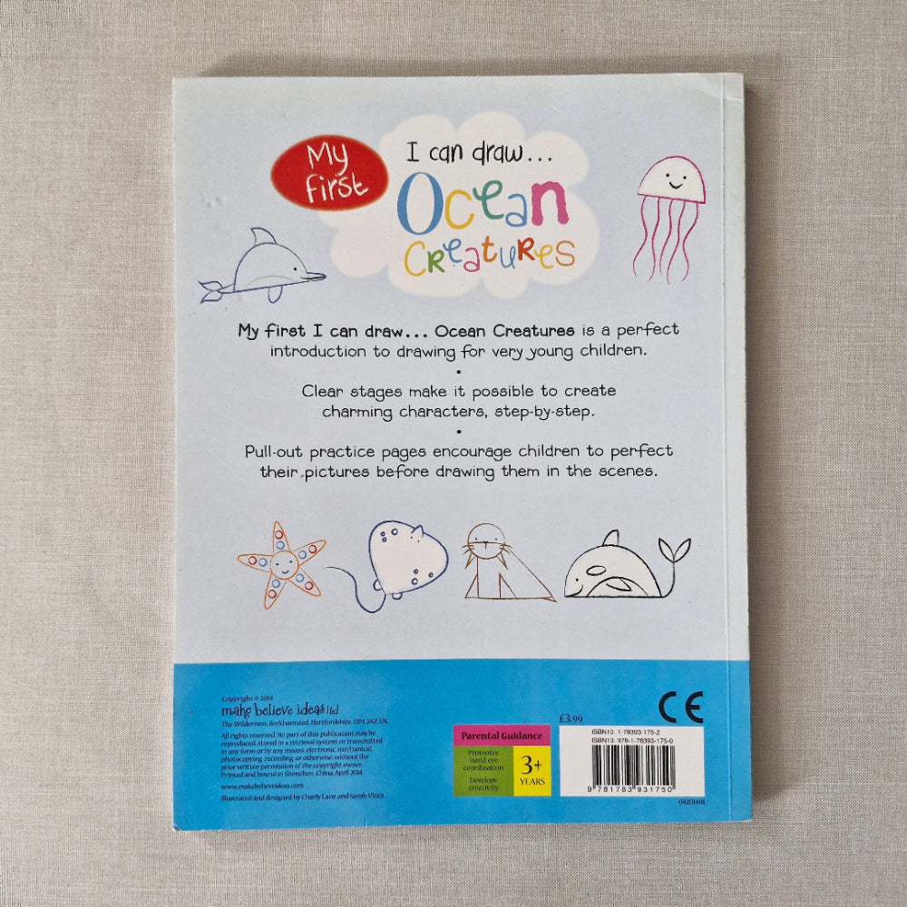Back cover of a children's book titled 'I can draw Ocean Creatures' on a textured surface.