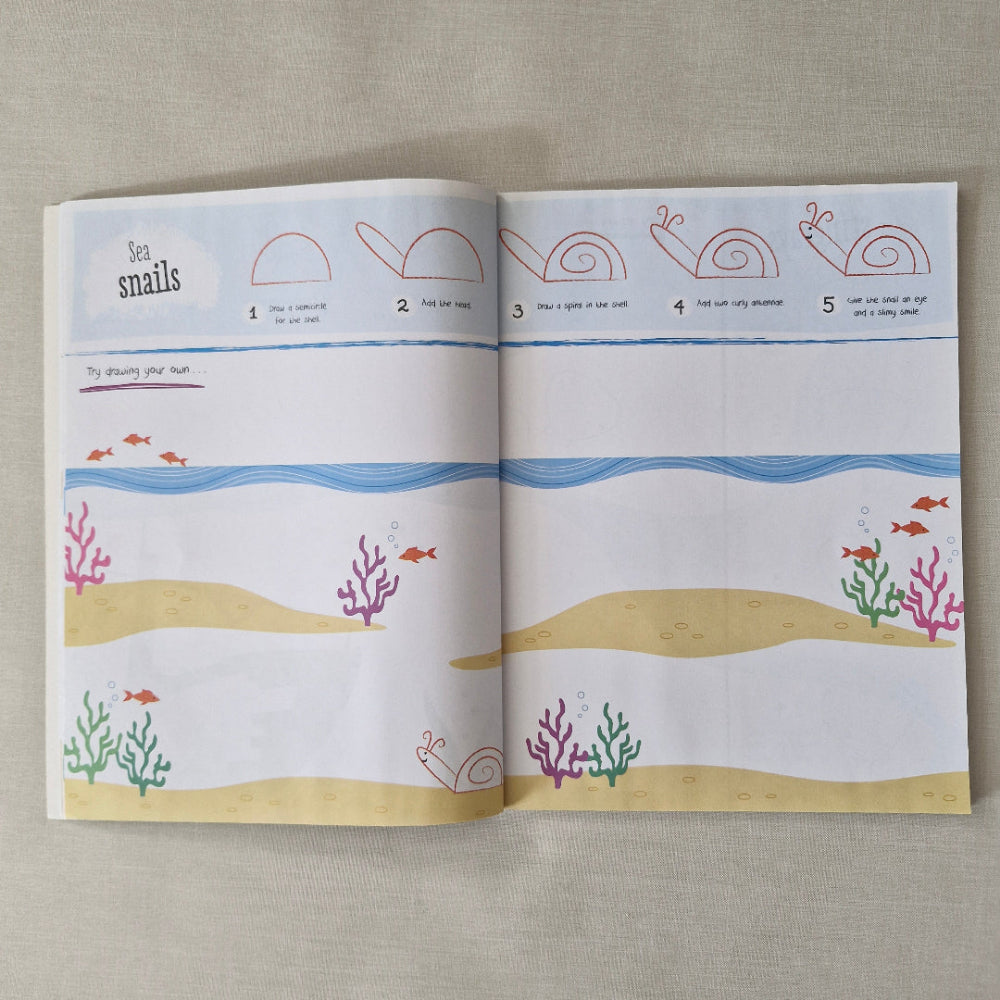 Open book with illustrations of snails, shells, and coral on a textured surface
