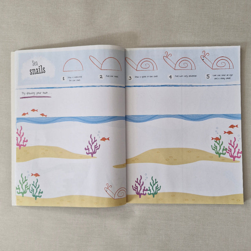 Open book with illustrations of snails, shells, and coral on a textured surface