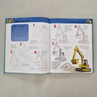 Open book with illustrations of a excavator on a textured surface