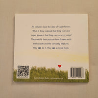 The back cover of a children's book titled 'They Can Achieve Them' by Silver Waters Books, displayed flat on a beige fabric background. The cover features a cream-colored background with black text, a yellow and green landscape illustration at the bottom, and a small red heart.