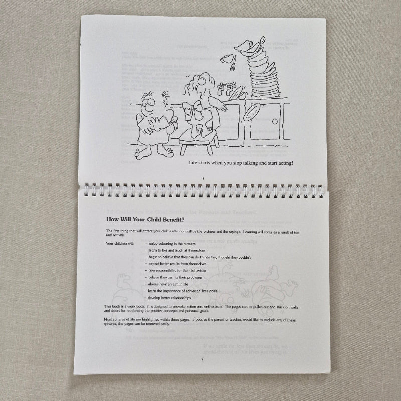 Spiral-bound book with cartoon illustration and text on a textured surface