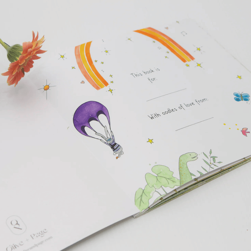 Children's book with illustrations of a hot air balloon, rainbow, and dinosaur on a white background.