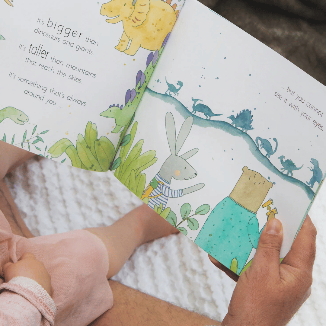 Child reading a children's book with illustrations of animals and text.