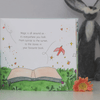Illustrated book with a message about magic and a plush rabbit toy in the background