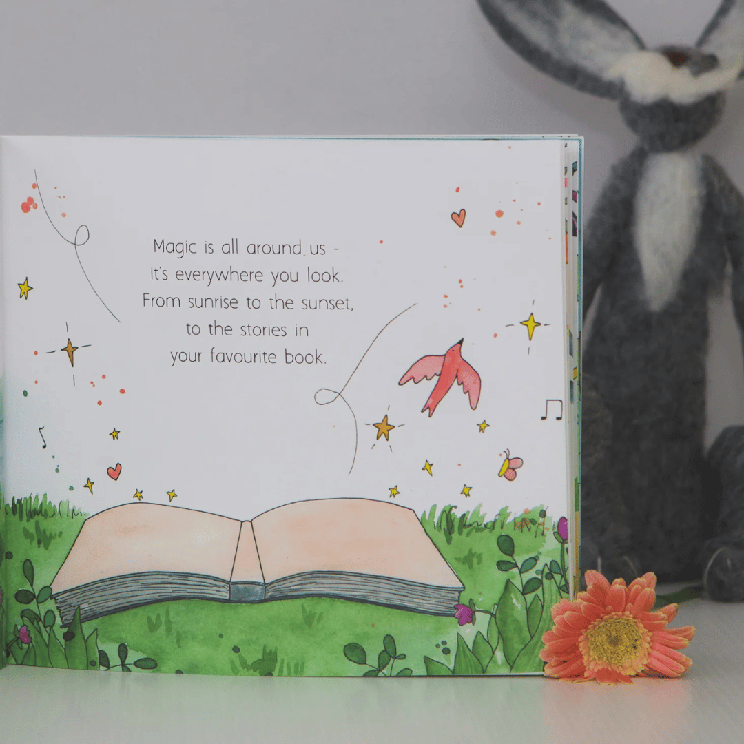 Illustrated book with a message about magic and a plush rabbit toy in the background