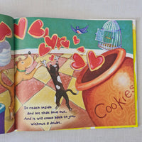 Colourful book cover with a cat, dog, and cookie jar illustration on a white background