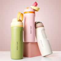 Three colorful water bottles with 'MODE & COAL' branding on a light pink background