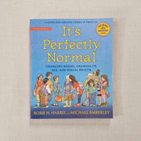 Book titled 'It's Perfectly Normal' on a beige background