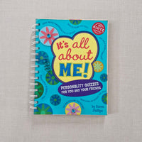 Colourful book titled 'It's All About Me' on a textured surface