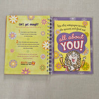 Open notebook with colorful pages on a textured surface