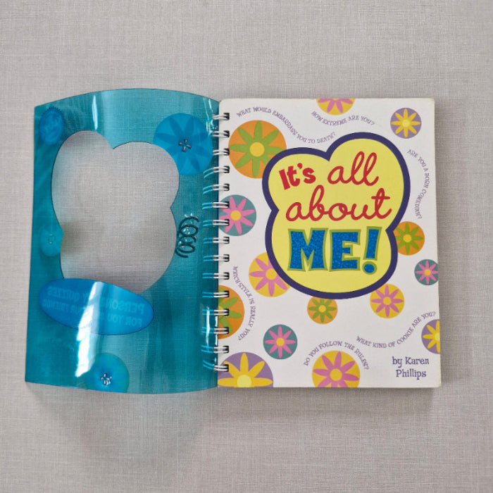 Book titled 'It's All About Me!' with colorful design on a gray background