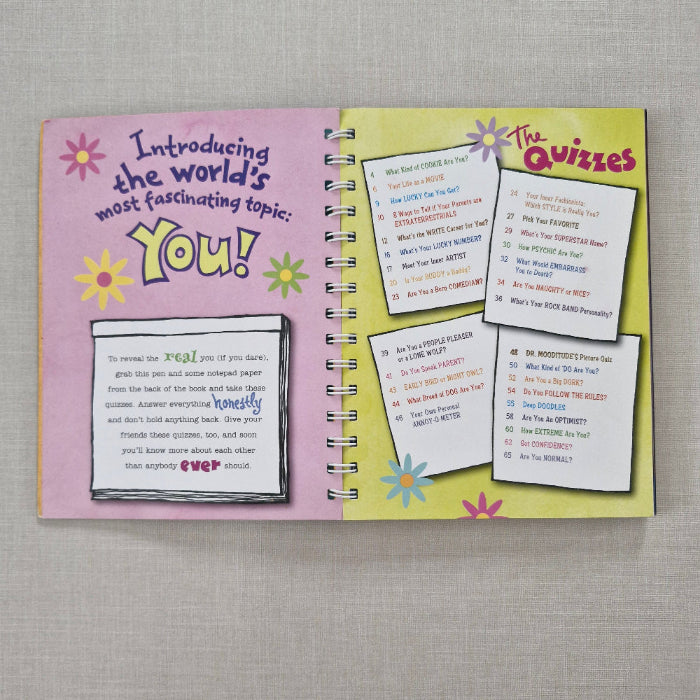 Book page with quiz cards on a textured surface