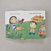 Children's book with illustrations of a boy and girl on a gray surface