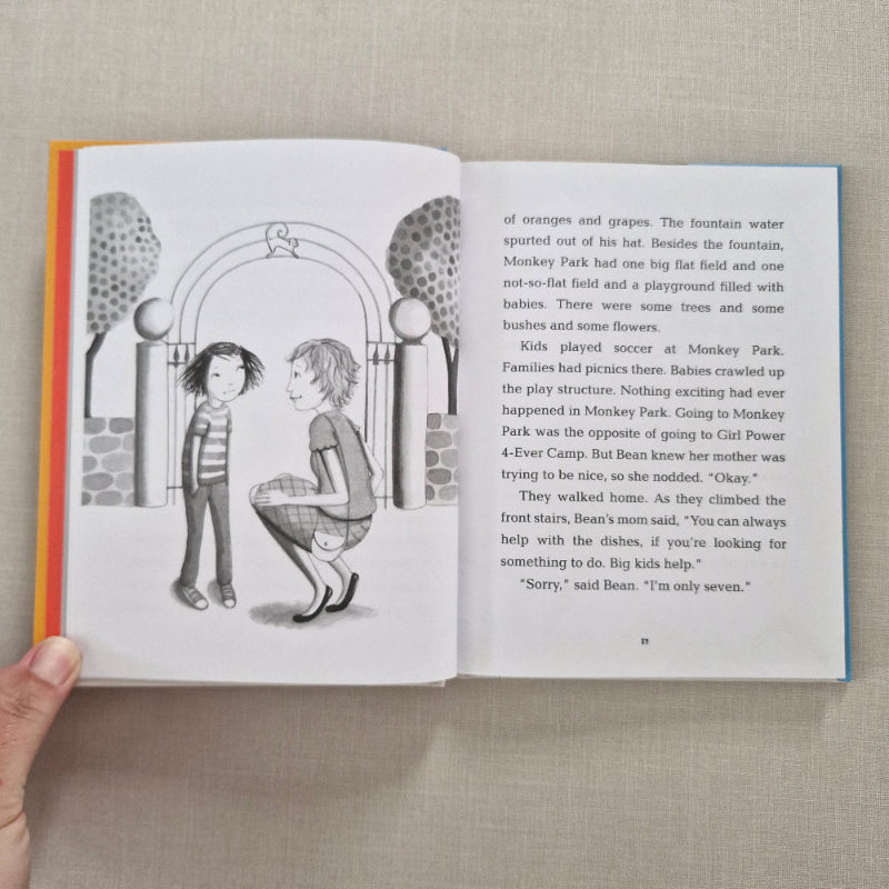 Open book with a illustration of two children by an archway against a beige background.