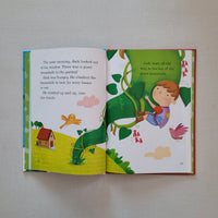 Open children's book with colourful illustrations and text on a plain background