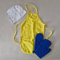 Yellow apron, blue oven mitt, and white chef's hat on a gray background