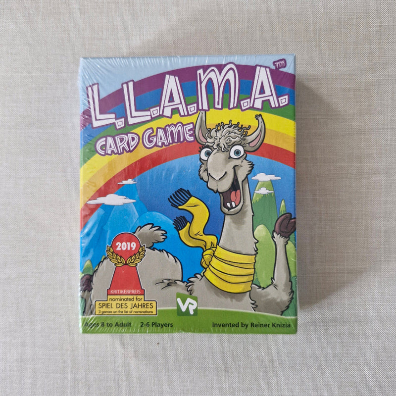 Card game box with cartoon llama design on a textured surface