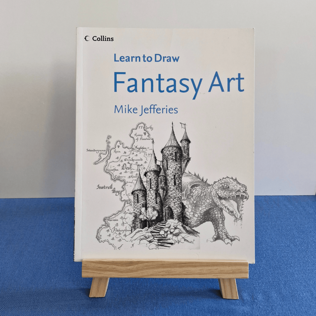 Book titled 'Learn to Draw Fantasy Art' by Mike Jefferies on a stand against a blue and gray background.