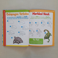 Open book showing illustrations of a marbled newt and Galapagos tortoise with labels and fun facts.