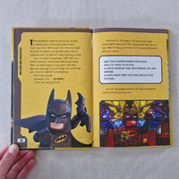 Open book with a Batman figure on a yellow background