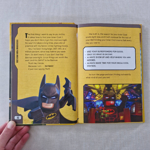 Open book with a Batman figure on a yellow background