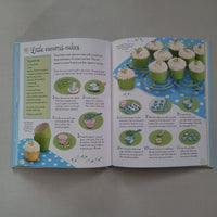 Open book with illustrations of coconut cakes on a gray background
