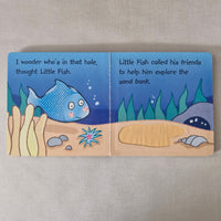 Illustrated children's book page with a fish character and underwater scene on a beige background
