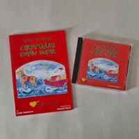 Red book and CD titled 'Love to Sing Christmas Down Under' on a grey surface.