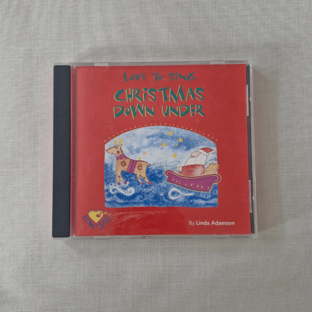 CD cover of 'Love to Sing Christmas Down Under' by Linda Adamson on a textured gray surface