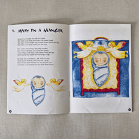 Open book with Christmas-themed illustration and text on a textured surface