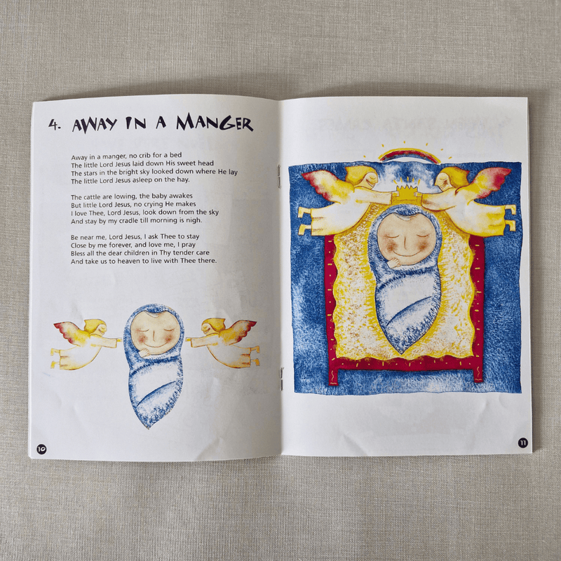 Open book with Christmas-themed illustration and text on a textured surface