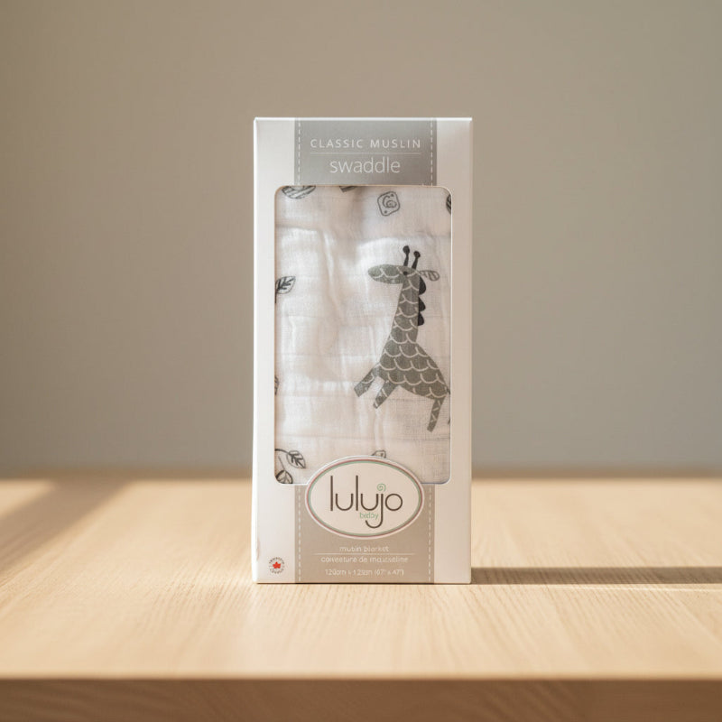 box packaging of swaddle blanket sitting on a bench