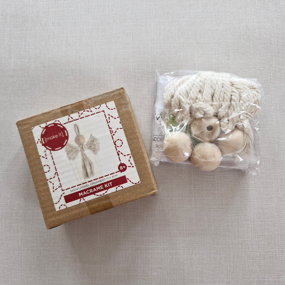 Crafting kit with yarn and beads on a textured surface