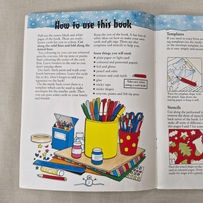 Open book with colouring and craft instructions on a textured surface
