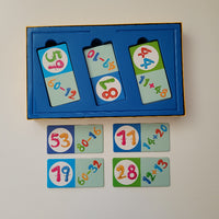 Educational math game with cards featuring numbers and equations on a white background