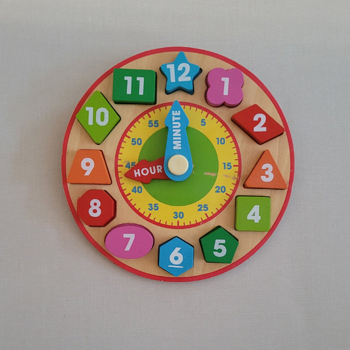 Colorful children's wooden clock puzzle on a plain background
