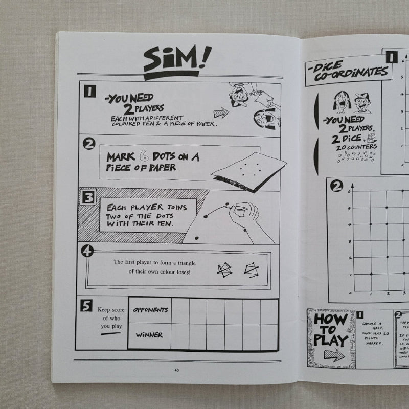Black and white game instructions in maths book on a textured surface