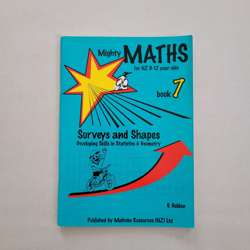 Book titled 'Mighty Maths Book 7' on a gray background