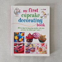Book titled 'My First Cupcake Decorating Book' on a gray background