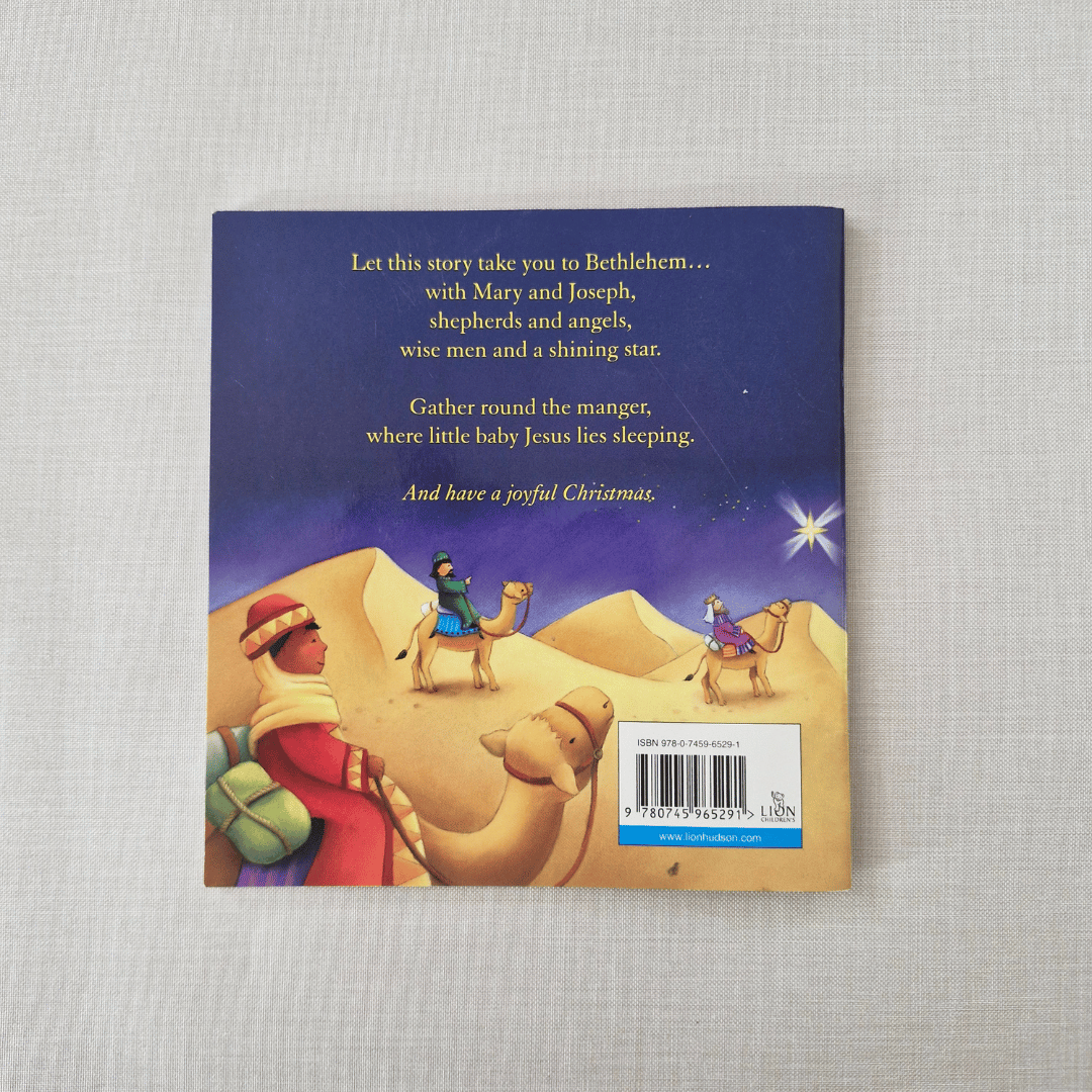 Back book cover with nativity scene illustration and text on a textured surface